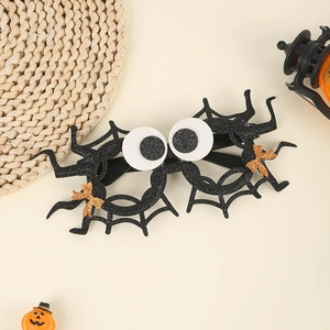 Detail of Halloween spider web glasses with white eyeballs and gold glitter bows