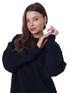 Close-up of black oversized fleece sweatshirt fabric and classic crew neck detail
