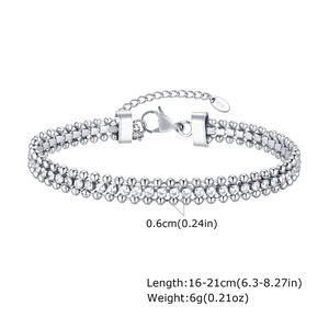 Detail of 18K gold triple layer chain bracelet with zircons and lobster clasp closure