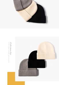 Detailed knit texture of cuffed fisherman beanies in black, beige, and grey colors