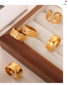 Detailed close-up of five vintage-style gold plated stainless steel textured rings