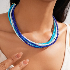 Close-up of blue and white multilayer seed bead necklace in Bohemian style on neck