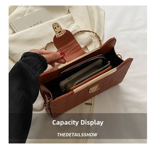 Macro detail of brown woven leather handbag interior showing storage for phone and wallet