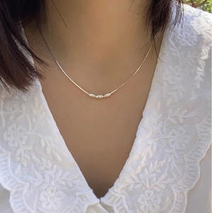Minimalist S925 sterling silver snake chain necklace with three oval beads on a model