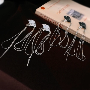 Elegant Chinese fan earrings with long tassels in black and white on vintage book background