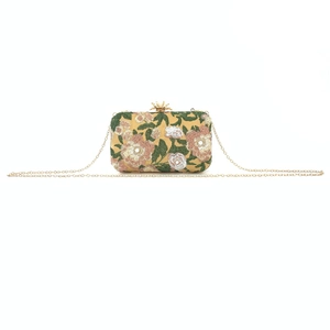 Detail of floral embroidery and gold beads on evening clutch with chain strap