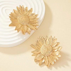 Golden irregular leaf earrings with a brushed metal texture and artistic design