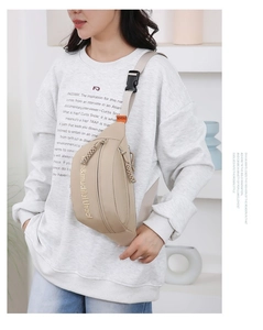 Detail of adjustable buckle and durable nylon strap on a khaki casual crossbody bag