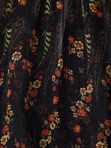 Macro detail of pleated floral chiffon fabric with paisley patterns and sheer texture