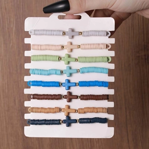 8-piece Bohemian clay disc bracelet set with cross charms on dark wood background