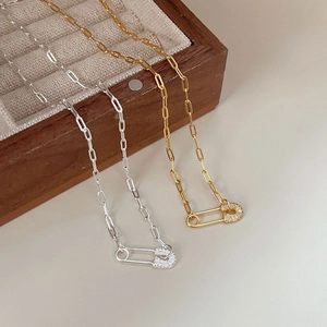 Close-up of 925 sterling silver paperclip chain necklaces in gold and silver finish