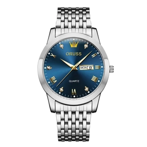 Close-up of a blue sunray dial with golden Roman numerals and a day-date window