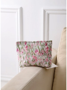 Floral fabric makeup bag with large capacity and H&R BAG label on a cozy sofa