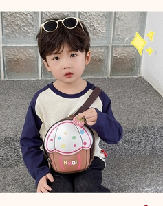 Detailed view of kids cupcake crossbody bag with cream top and colorful polka dots