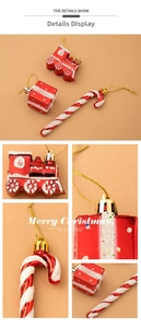 Detailed macro view of red and white Christmas train, gift box and candy cane ornaments