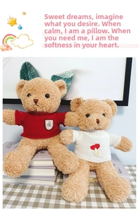Close-up of plush teddy bears in red and white knit sweaters with heart embroidery