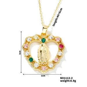 Macro shot of Virgin Mary heart pendant with multi-colored crystals and gold finish