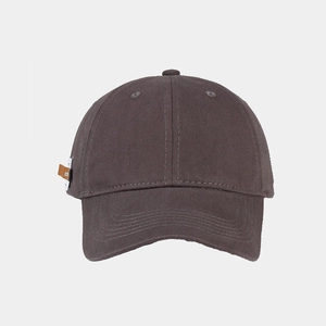 Detail view of cotton baseball cap fabric texture and brown leather side label