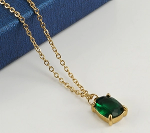 Detail of emerald green zircon pendant with four-prong setting on 18K gold chain