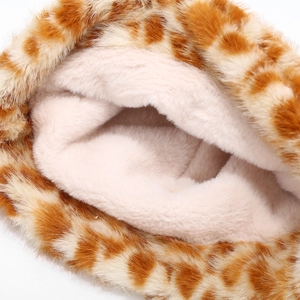 Detailed macro view of the thick white faux fur lining and plush giraffe pattern fabric