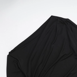 Detail of the elegant black ruched dress showing the asymmetric off-shoulder neckline