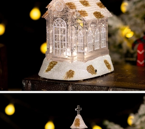 Detailed close-up of a Christmas LED crystal church music box with sparkling golden glitter