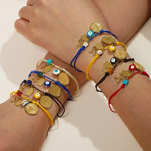 Handmade woven cross and evil eye charm bracelets in various colors for protection