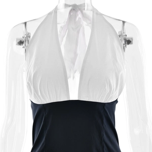Detail view of deep V-neck halter design with elegant pleats and waist seam on the dress