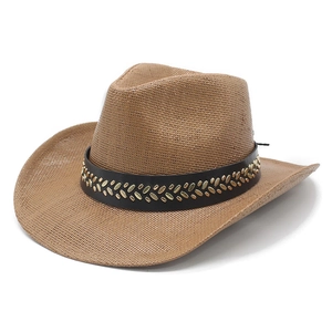 Close-up of woven straw cowboy hat with black leather band and gold metal studs decoration
