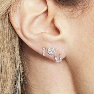 Macro shot of silver I Heart U ear stud set with sparkling cubic zirconia pavé
