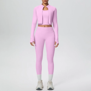 Detailed view of pink three-piece yoga set with thumb hole sleeves and high waist pants