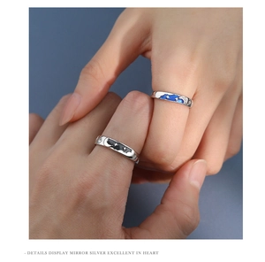 Close-up of S925 silver couple rings with blue and black star-moon enamel details