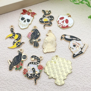 Detailed macro view of 10 Gothic enamel alloy charms featuring skull, snake, and raven designs