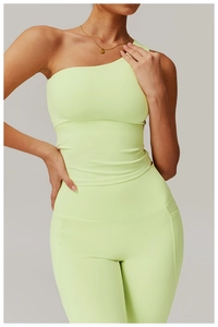 Detail of lime green one-shoulder yoga vest and high-waisted leggings with side pocket