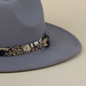 Detail of grey wool fedora hat featuring leopard print band and silver metal buckle