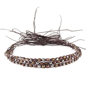 Close-up of triple-layered braided cord bracelet with mixed metal beads in ethnic style