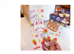 Close-up of cute cartoon waterproof transparent stickers featuring rabbits and rainbows