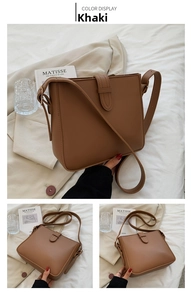 Detailed view of a vintage brown bucket bag featuring decorative buckle and adjustable strap