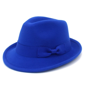 Detail of royal blue fedora hat featuring a matching ribbon bow and felt texture