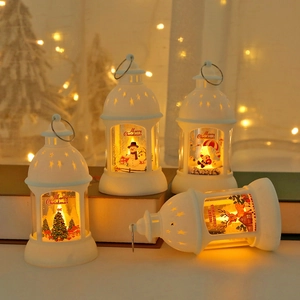 Set of four white LED Christmas lanterns with festive Santa and snowman patterns