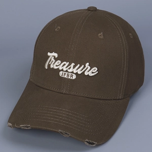 Detailed close-up of 3D embroidery and vintage distressed brim on dark brown baseball cap