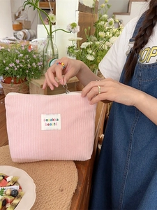 Pink corduroy makeup bag with large capacity and portable zipper closure for daily use