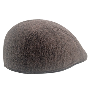 Close-up of winter flat cap showing premium dark brown herringbone wool texture and weave