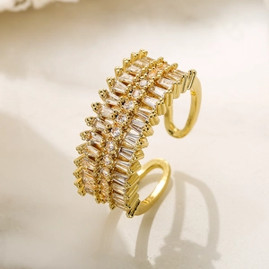 Elegant gold plated multi-layer ring with rectangular zircon stones on a stone surface
