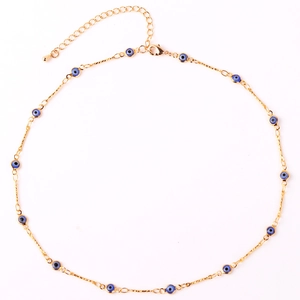 Detailed view of gold plated evil eye necklace with multiple blue enamel eye charms