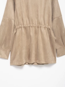 Detail of khaki faux suede jacket showing adjustable drawstring waist and soft texture