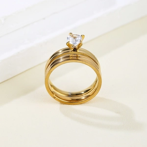 Elegant gold-plated double layer ring set featuring a brilliant round-cut cubic zirconia stone