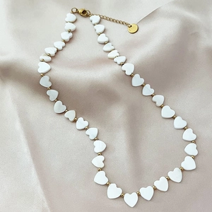 Elegant gold-plated stainless steel necklace with heart-shaped shell beads on silk