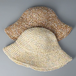 Close-up of two handmade colorful crochet straw sun hats for women on grey background