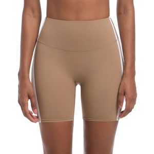 Close-up of high-waisted yoga shorts featuring white side stripes and breathable fabric